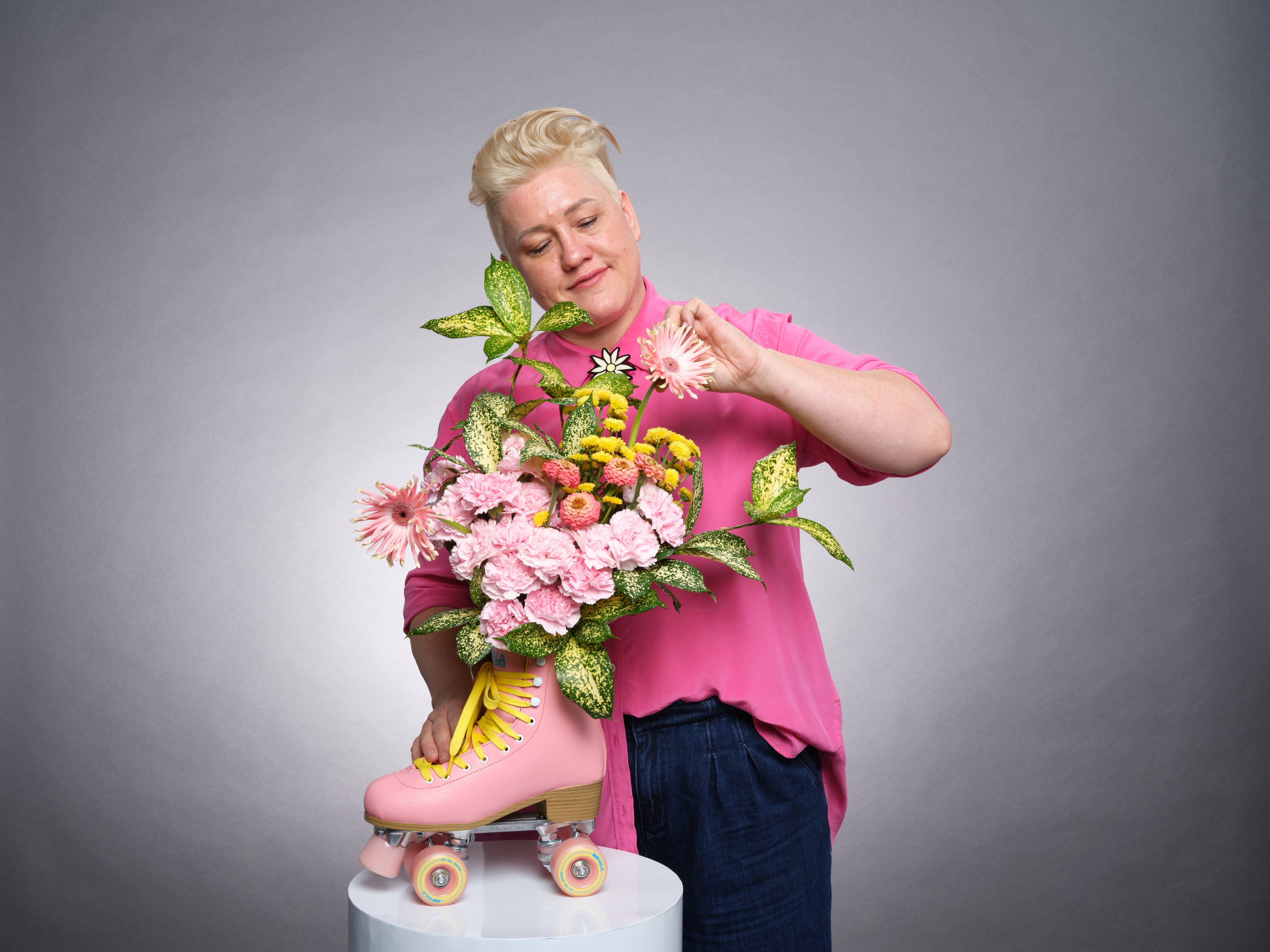 Suz from Bold Botanicals creating a colourful floral arrangement in a pink rollerskate