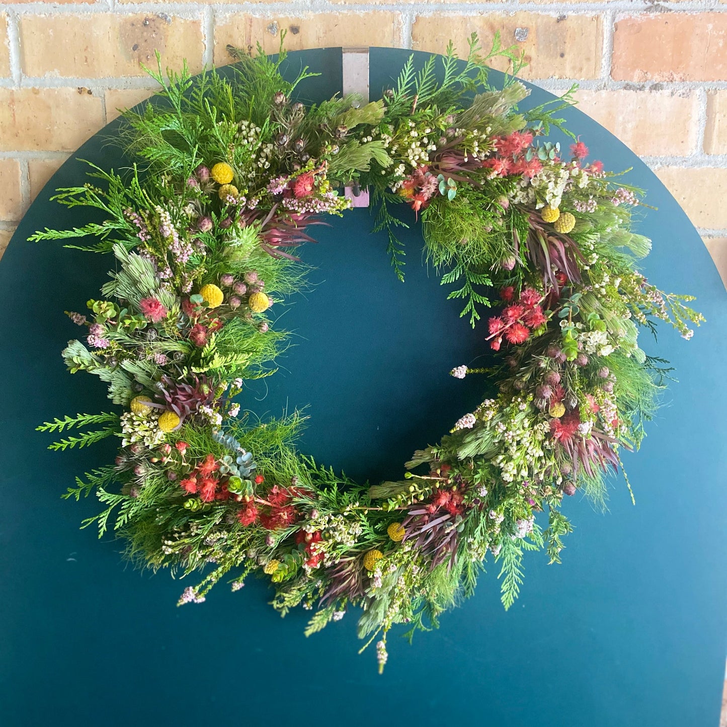 Bold Botanicals Fresh Traditional Christmas Wreath with red focal flowers