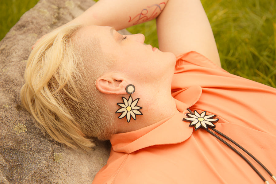 Doodad and Fandango designed earrings and boho tie on a model depicting a Flannel Flower. Shot in the bush, against a gum tree.