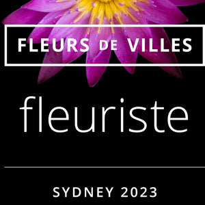 Half a purple flower displaying the text logo for Fleurs De Villes