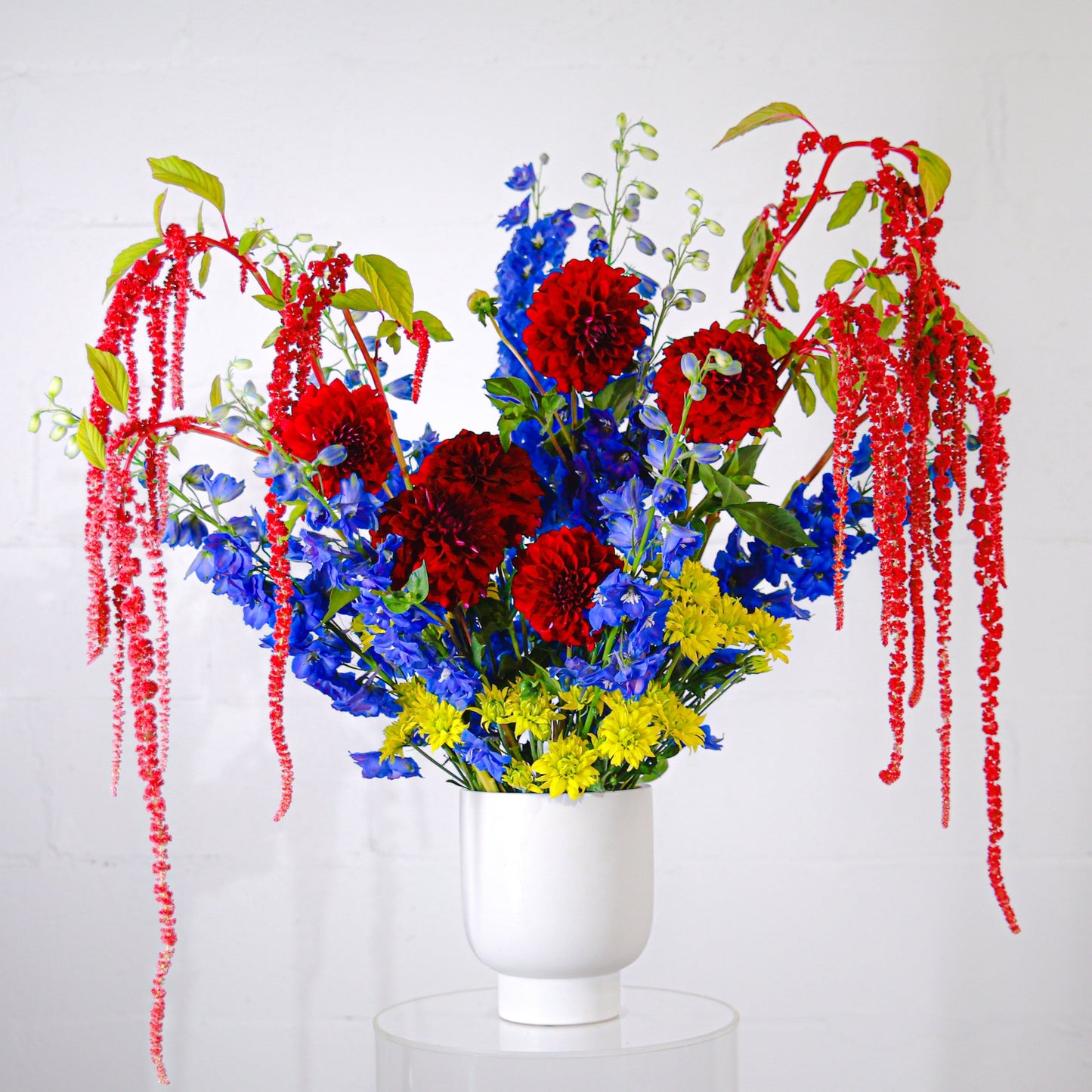 Primary colour large flower arrangement for corporate, real estate or reception in a white ceramic pot