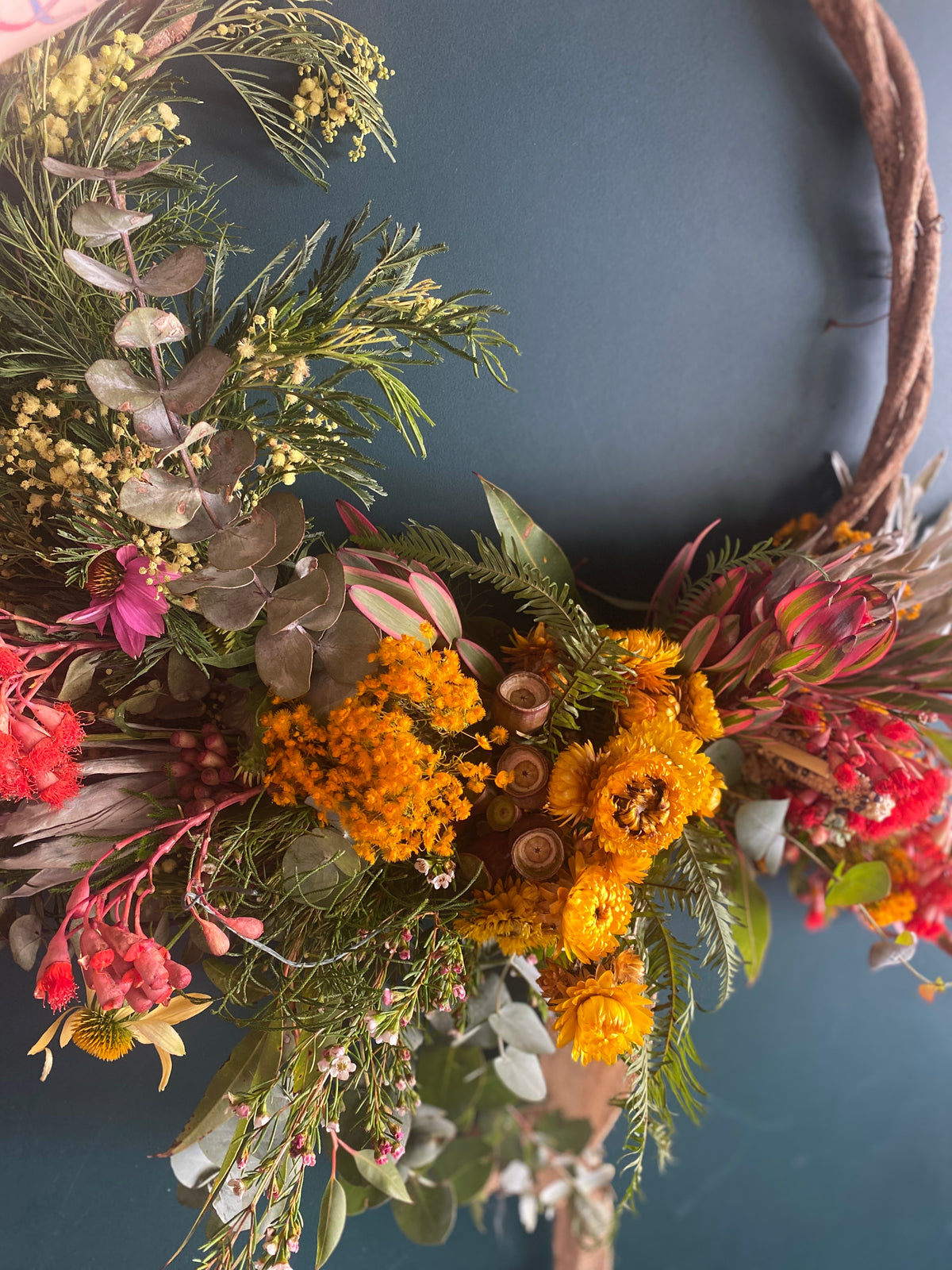 Bespoke Native Flower Christmas wreath  in red and gold by Bold Botanicals