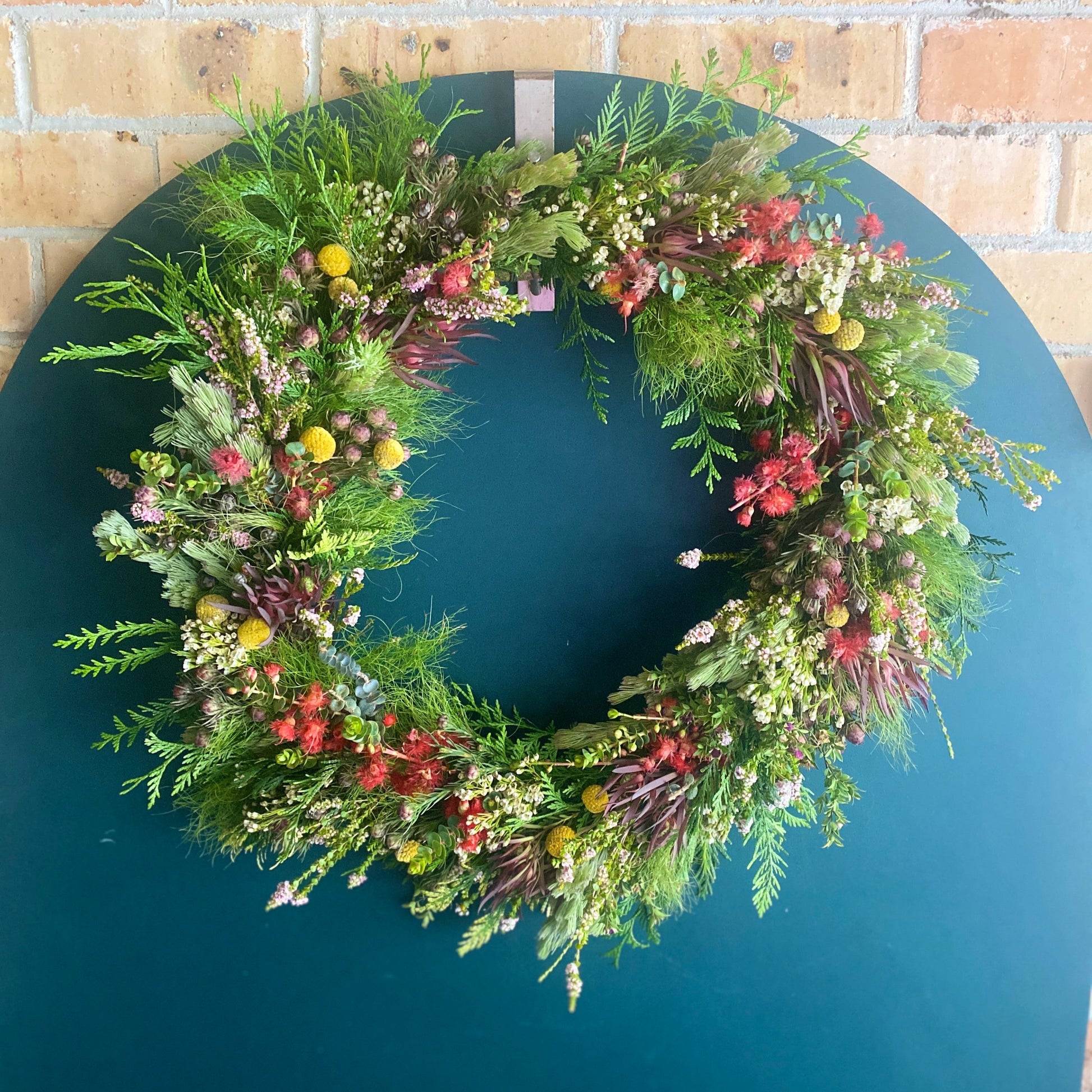 Bold Botanicals Fresh Traditional Christmas Wreath with red focal flowers