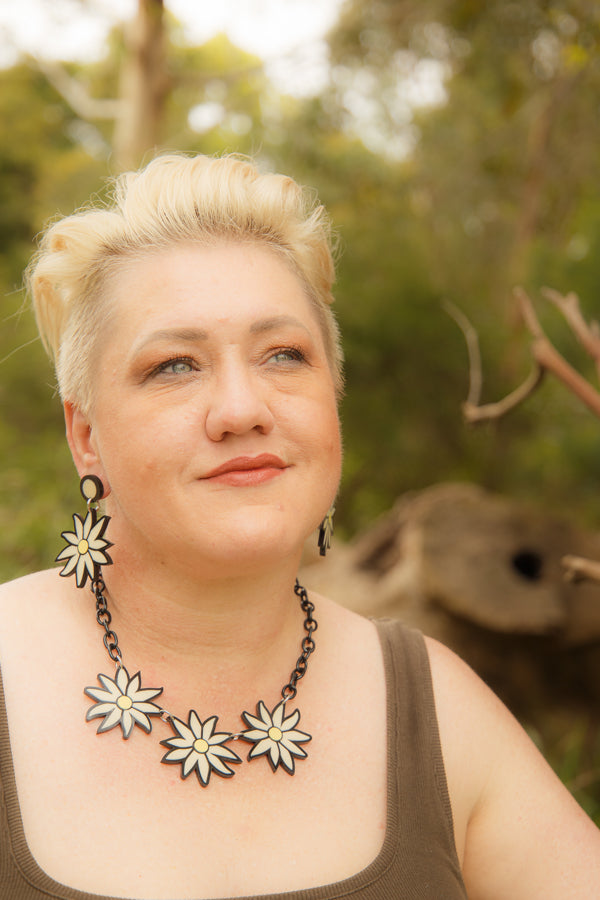 Modal showing doodad x fandango flannel flower earrings and necklace in nature