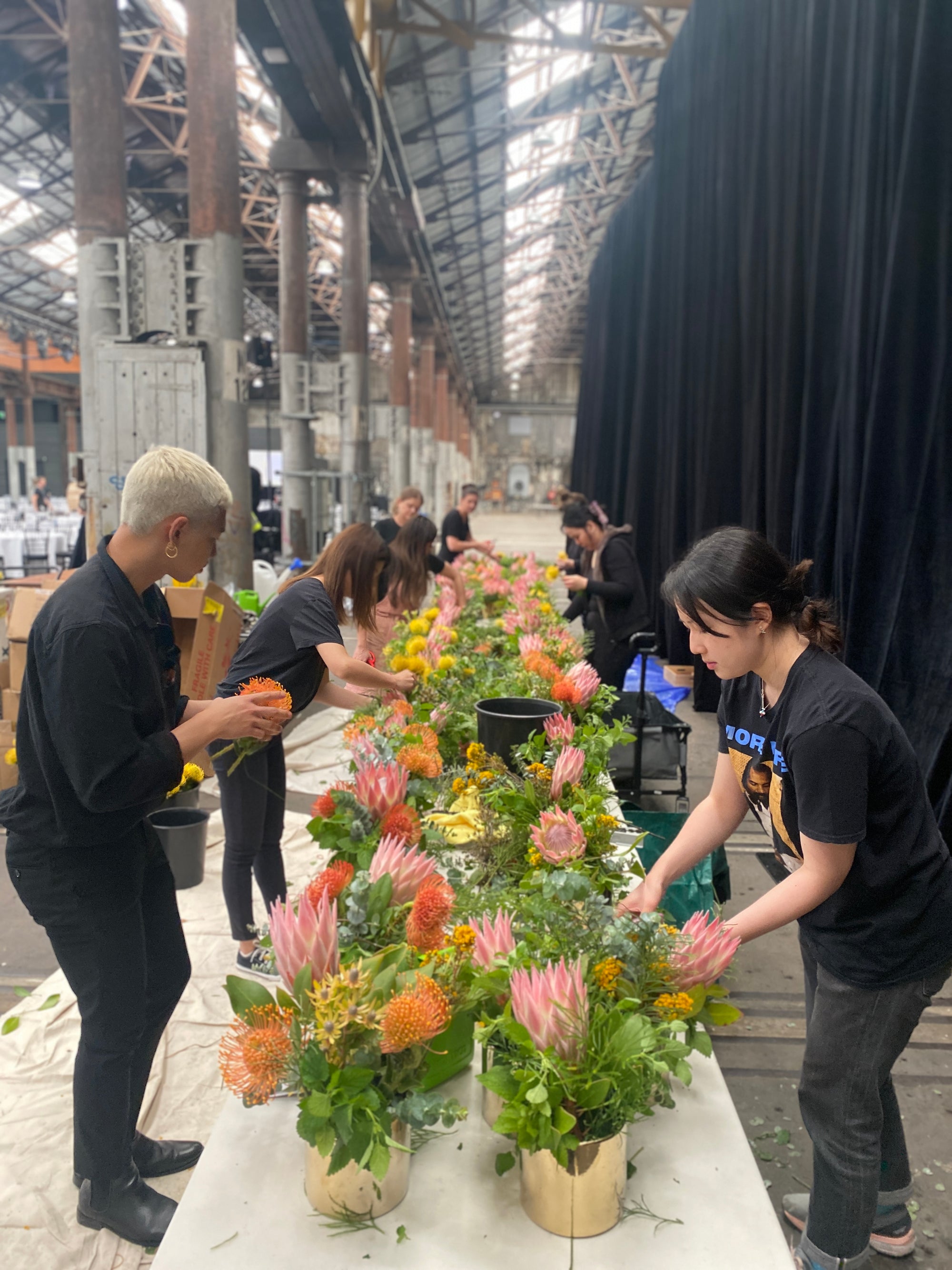Two students at a Bold Botanical workshop helping create native Australia flower arrangements