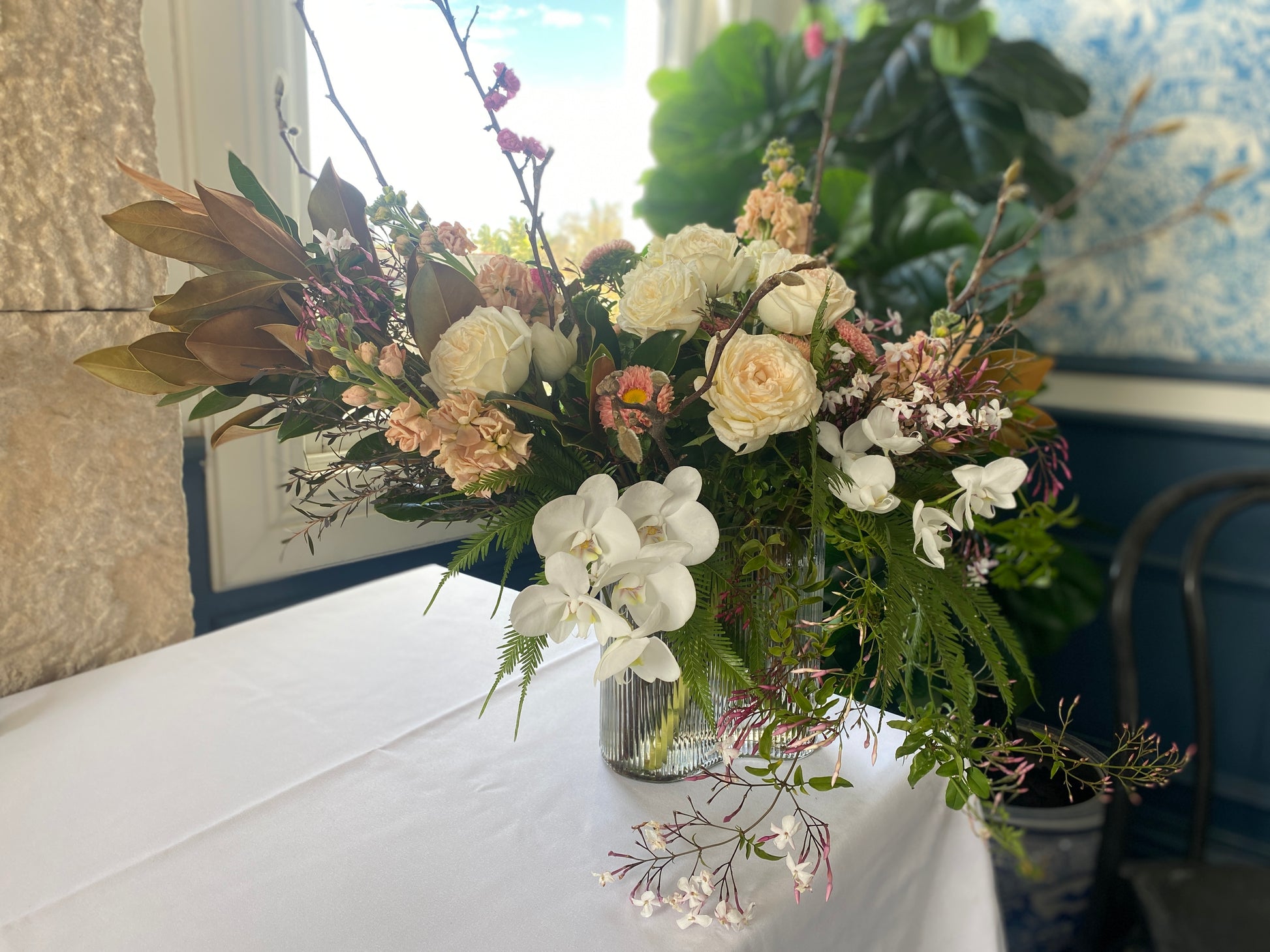 Large vase floral arrangement with seasonal white and cream flowers by Bold Botanicals