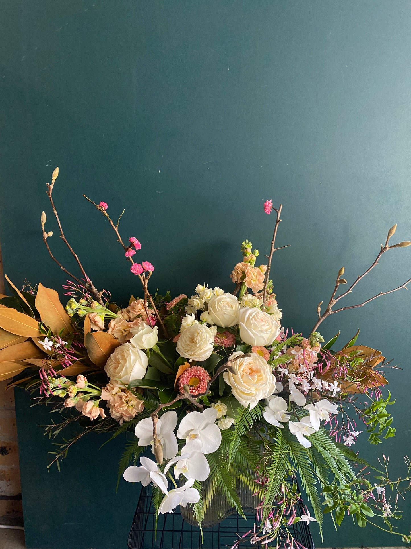 A floral arrangement of white, cream, pink and purple flowers made by Bold Botanicals