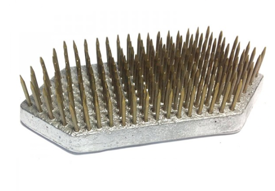A large, hexagon shaped Kenzan flower pin, used for foam free flower arranging in a vase