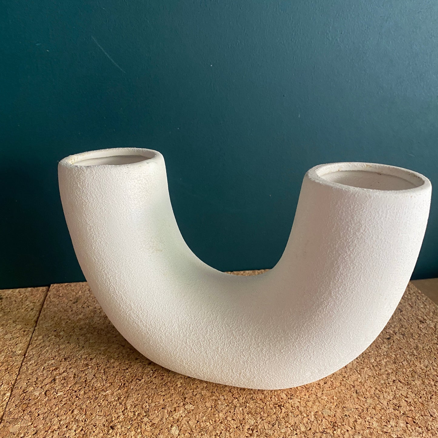 White ceramic U-shaped vase