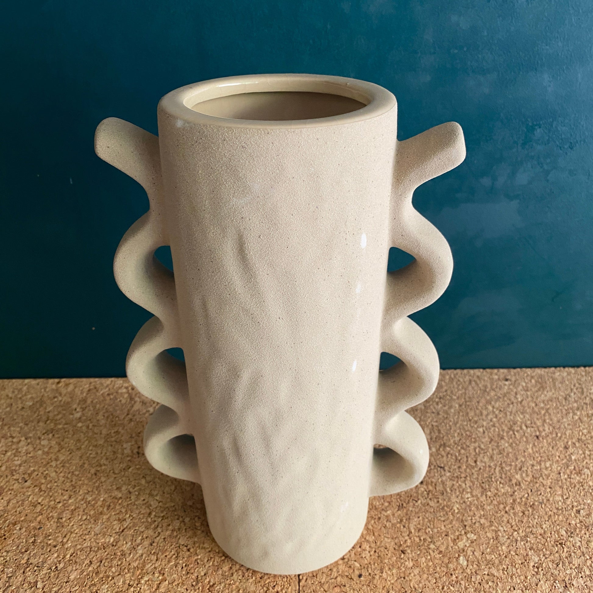 Tall cream textured modern vase with squiggle arms