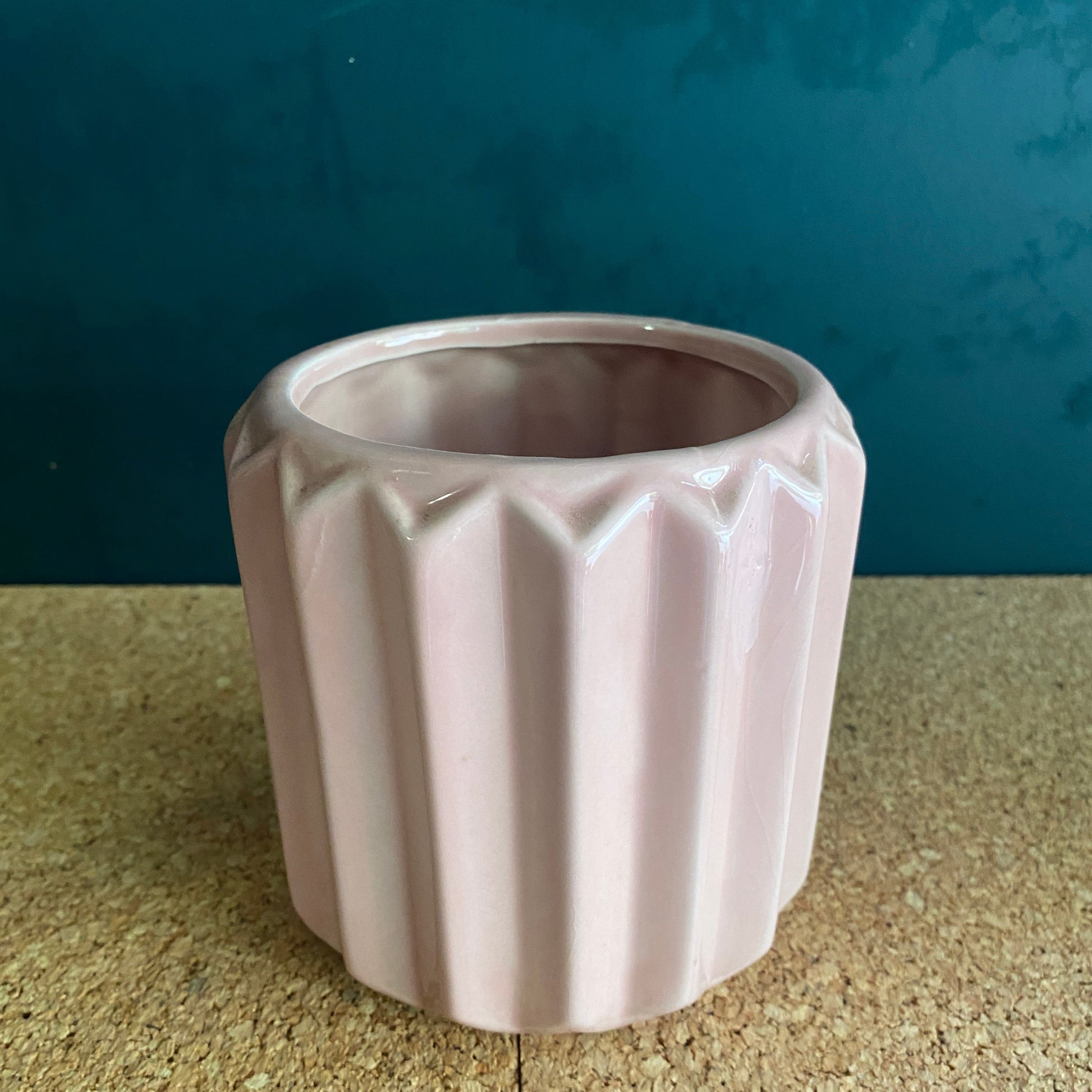 Round soft pink ceramic vase with geometric rib shape