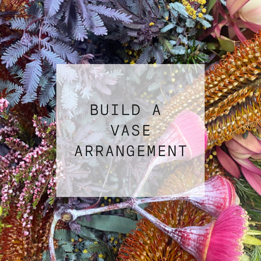 Text 'Build a Vase Arrangement' surrounded by various flowers and plants.