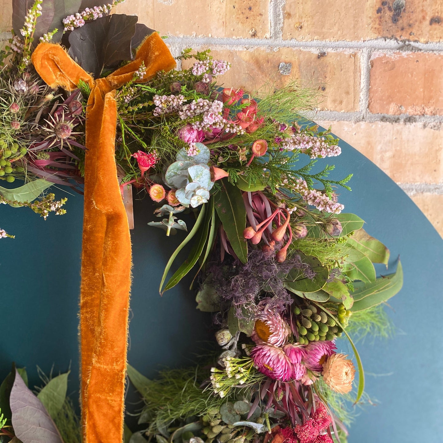 Bold Botanicals Christmas Wreath in pink and plum showcasing native flowers and foliage