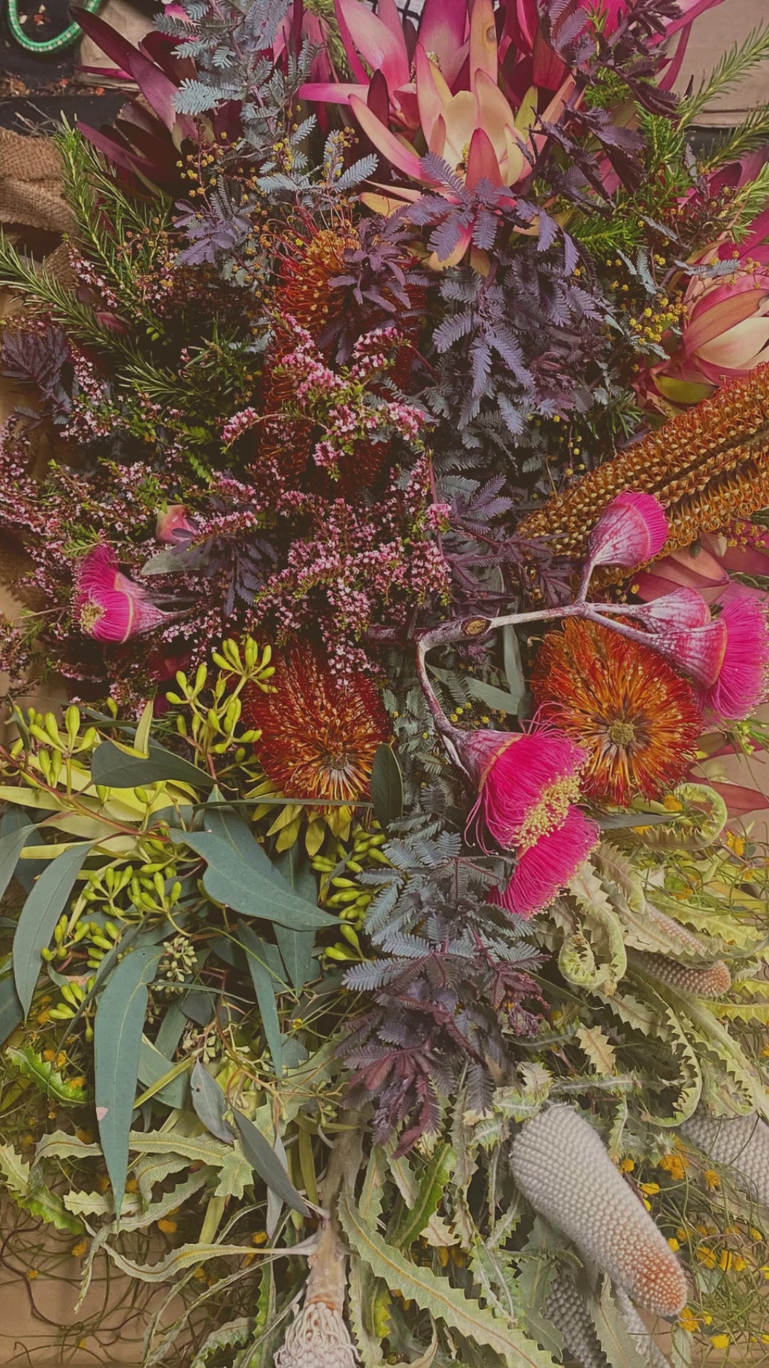 A tribute video showcasing stunning funeral flower designs for a casket.